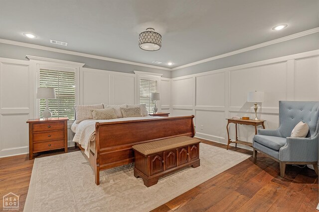 803 Fairway Dr, Jonesboro, AR 72401 - bedroom with a decorative wall, ornamental molding, visible vents, recessed lighting, and wood-type flooring