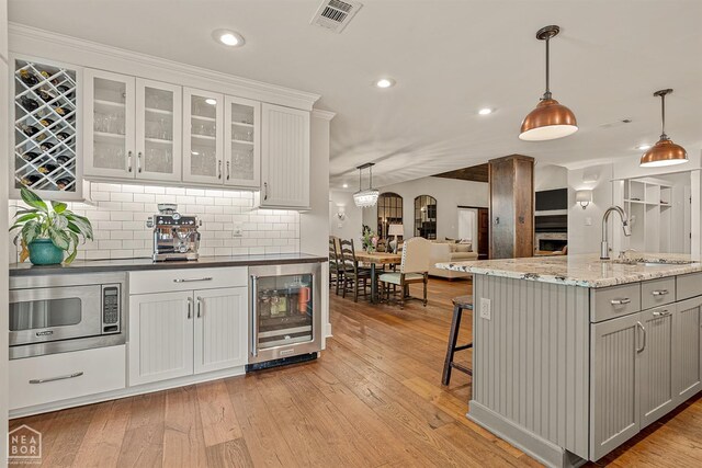 803 Fairway Dr, Jonesboro, AR 72401 - kitchen featuring visible vents, recessed lighting, stainless steel microwave, a sink, and beverage cooler