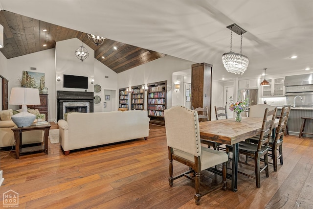 803 Fairway Dr, Jonesboro, AR 72401 - dining space featuring light wood-type flooring, an inviting chandelier, a fireplace, and recessed lighting