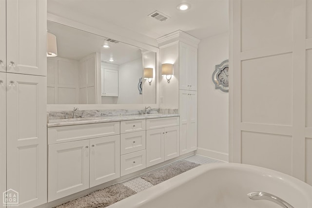 803 Fairway Dr, Jonesboro, AR 72401 - bathroom with a freestanding tub, a sink, and visible vents