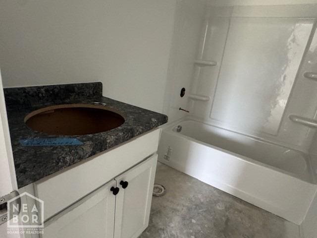 5702 Crockett Dr, Jonesboro, AR 72404 - full bath with vanity, unfinished concrete floors, and washtub / shower combination