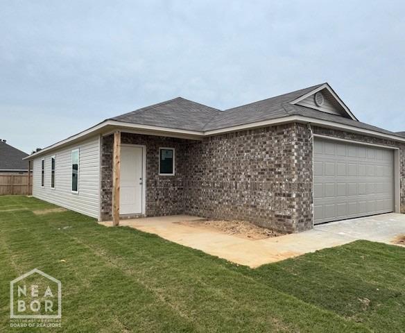 5702 Crockett Dr, Jonesboro, AR 72404 - view of front of home featuring an attached garage, brick siding, and concrete driveway