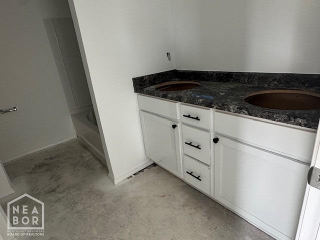 5702 Crockett Dr, Jonesboro, AR 72404 - full bath featuring concrete floors, double vanity, a bath, and a shower