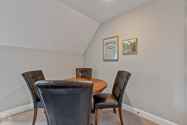 3293 Abigail Ct, Jonesboro, AR 72404 - carpeted dining area with baseboards, vaulted ceiling, and a textured ceiling