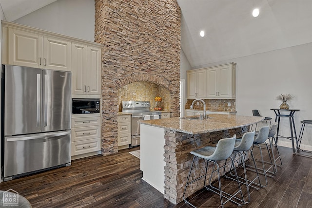 3293 Abigail Ct, Jonesboro, AR 72404 - kitchen with stainless steel appliances, dark wood-style flooring, light stone counters, cream cabinets, and recessed lighting