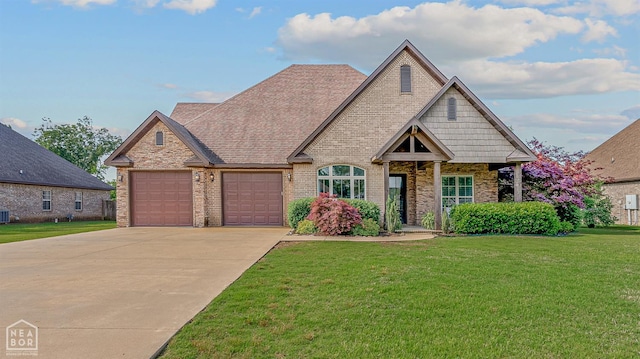 3293 Abigail Ct, Jonesboro, AR 72404 - view of front facade with a garage, concrete driveway, brick siding, a front lawn, and central air condition unit