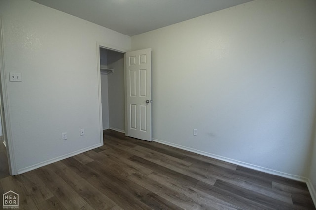 2404 Judes Ct, Jonesboro, AR 72404 - unfurnished bedroom featuring dark wood-style floors and a closet