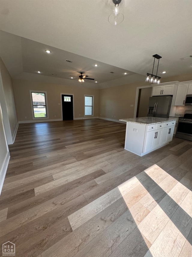 100 Lenford Dr, Bono, AR 72416 - kitchen with appliances with stainless steel finishes, wood finished floors, open floor plan, white cabinets, and recessed lighting