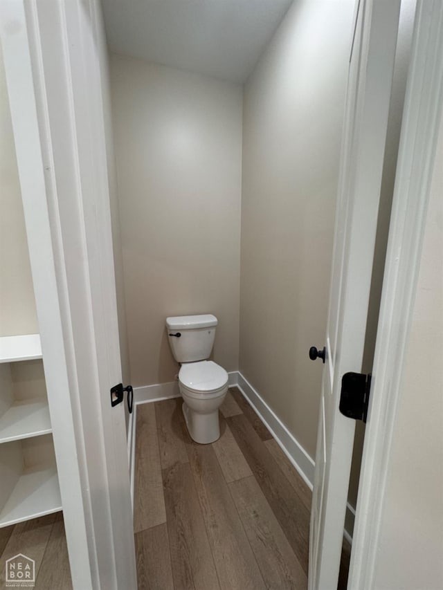 100 Lenford Dr, Bono, AR 72416 - bathroom with wood finished floors, toilet, and baseboards