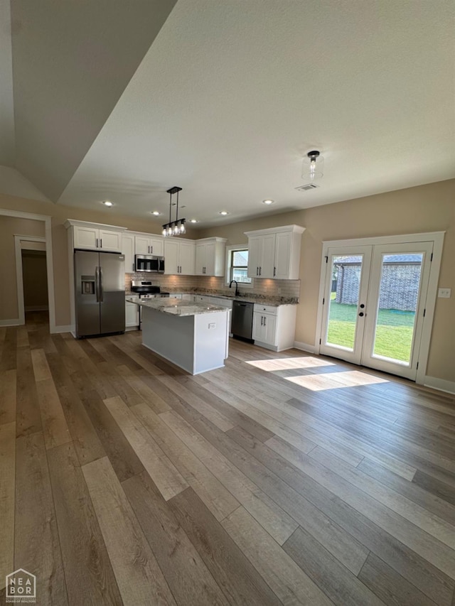 100 Lenford Dr, Bono, AR 72416 - kitchen with appliances with stainless steel finishes, recessed lighting, hardwood / wood-style flooring, and white cabinets