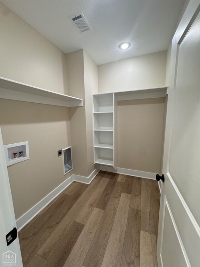 100 Lenford Dr, Bono, AR 72416 - laundry room featuring wood finished floors, hookup for a washing machine, electric dryer hookup, baseboards, and recessed lighting