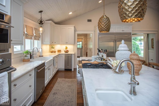 1105 Cardinal Rd, Jonesboro, AR 72401 - kitchen featuring stainless steel appliances, lofted ceiling, dark wood-type flooring, recessed lighting, and white cabinets