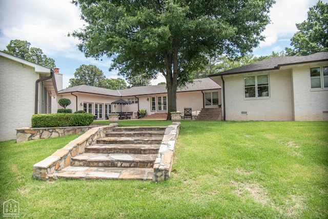 1105 Cardinal Rd, Jonesboro, AR 72401 - rear view of house with a lawn, french doors, brick siding, and a shingled roof