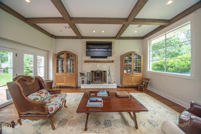 1105 Cardinal Rd, Jonesboro, AR 72401 - living area featuring coffered ceiling, a stone fireplace, beamed ceiling, wood finished floors, and recessed lighting