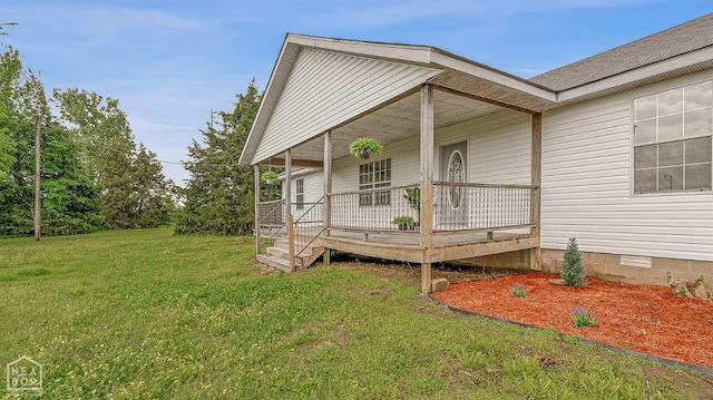 exterior space featuring a porch, a yard, and crawl space