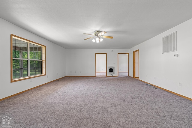 empty room with a ceiling fan, visible vents, and baseboards