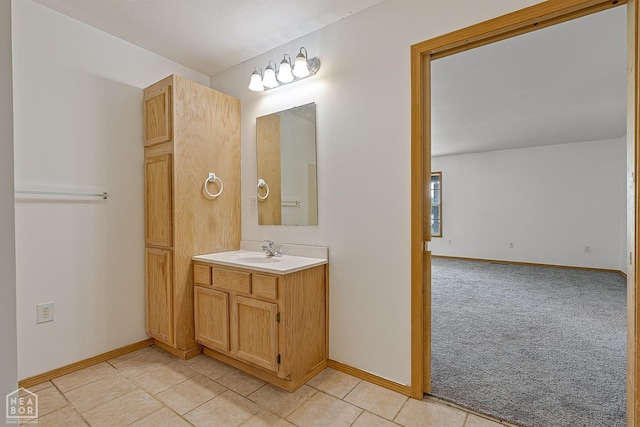 bathroom with tile patterned floors, vanity, and baseboards