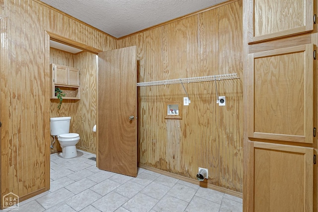 laundry area featuring laundry area, hookup for an electric dryer, ornamental molding, washer hookup, and a textured ceiling