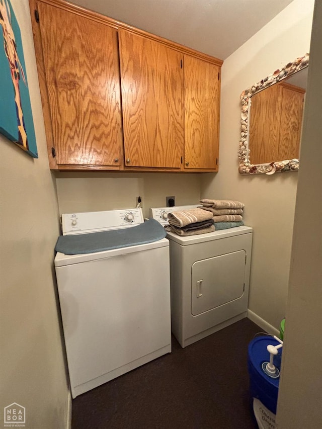 laundry room featuring separate washer and dryer and cabinet space