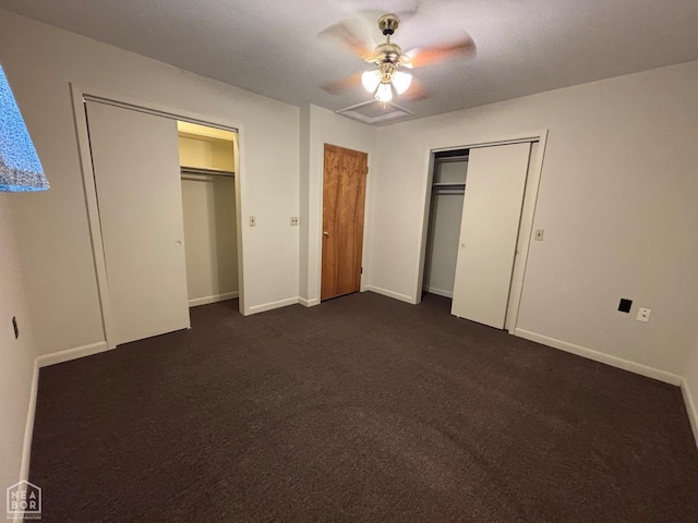 204 SE 4th St E, Walnut Ridge, AR 72476 - unfurnished bedroom with two closets, dark carpet, baseboards, and a ceiling fan