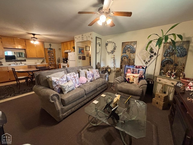 living room featuring ceiling fan and carpet floors