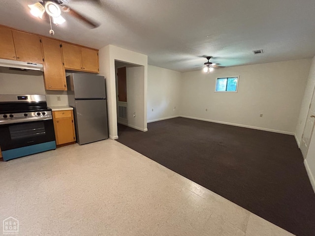 204 SE 4th St E, Walnut Ridge, AR 72476 - kitchen with appliances with stainless steel finishes, a ceiling fan, under cabinet range hood, baseboards, and light countertops