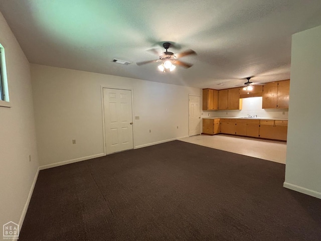 204 SE 4th St E, Walnut Ridge, AR 72476 - unfurnished living room featuring a ceiling fan, baseboards, a sink, and light colored carpet
