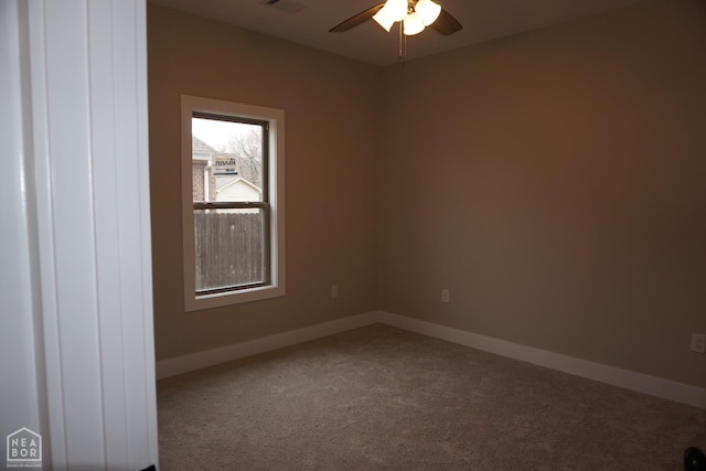 carpeted empty room featuring visible vents, baseboards, and ceiling fan
