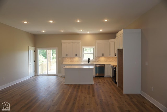 kitchen featuring a sink, white cabinets, dark wood-style flooring, dishwasher, and tasteful backsplash