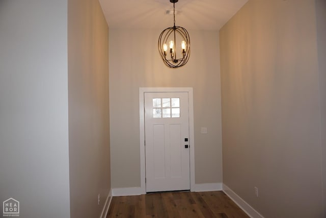 doorway to outside with a notable chandelier, baseboards, visible vents, and dark wood finished floors