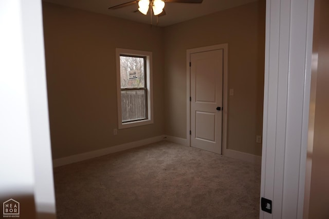 spare room with a ceiling fan, baseboards, and carpet floors