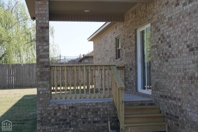 exterior space with a deck and fence