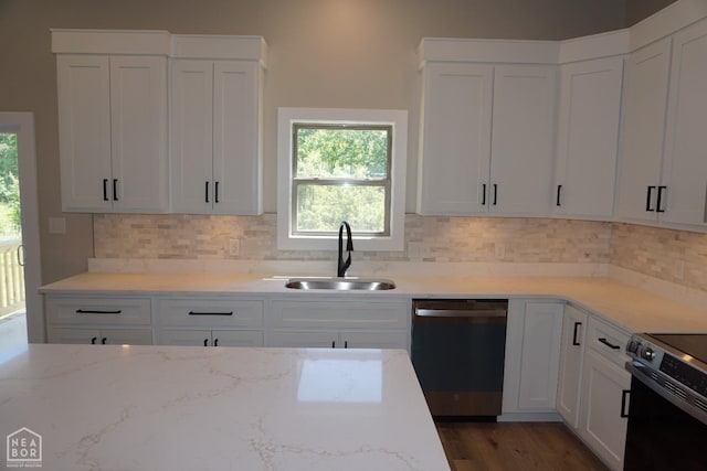 kitchen with dishwasher, light stone countertops, a sink, and electric stove