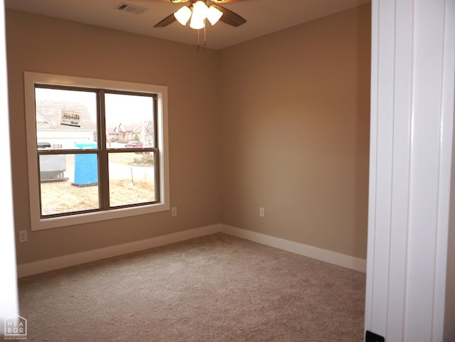 unfurnished room with ceiling fan, carpet, baseboards, and visible vents