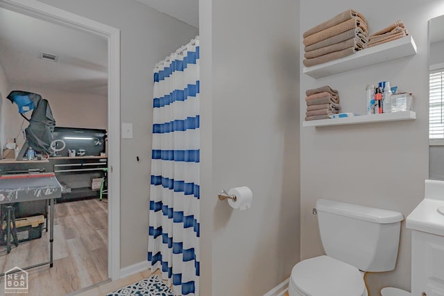 full bath with visible vents, a shower with curtain, toilet, and wood finished floors
