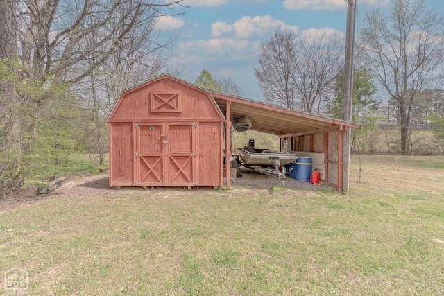view of outbuilding featuring an outbuilding, an attached carport, and driveway