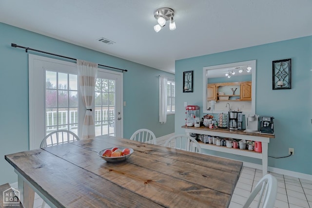 dining room featuring visible vents, baseboards, and light tile patterned flooring