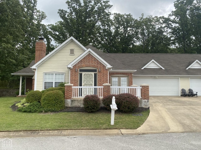1811 Frank Hall Cir, Jonesboro, AR 72401 - view of front of home with brick siding, concrete driveway, a front lawn, and roof with shingles