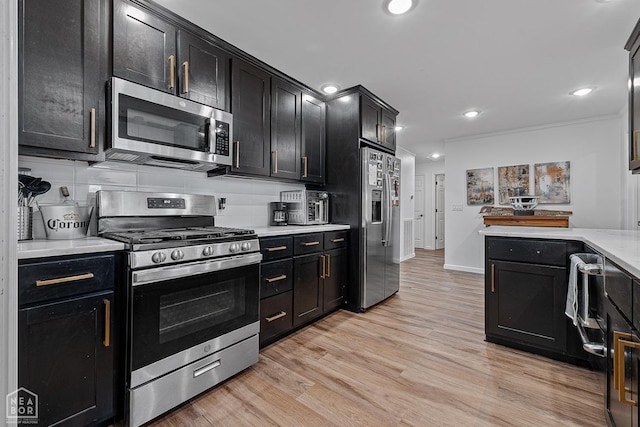 608 Finch Ave, Monette, AR 72447 - kitchen with stainless steel appliances, dark cabinets, light countertops, light wood-style floors, and recessed lighting