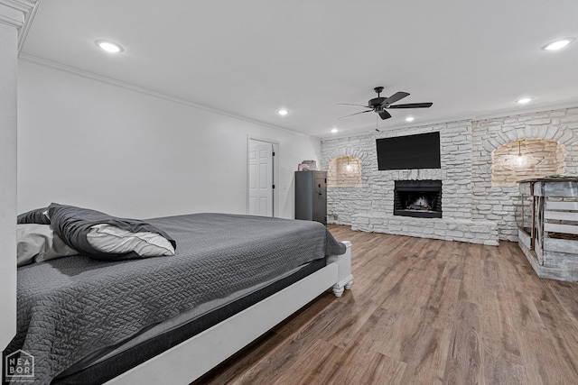608 Finch Ave, Monette, AR 72447 - bedroom with ornamental molding, wood finished floors, recessed lighting, a stone fireplace, and a ceiling fan