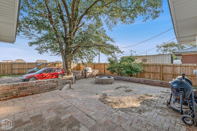 608 Finch Ave, Monette, AR 72447 - fenced backyard with an outdoor fire pit, a patio area, and area for grilling