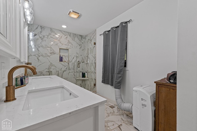 608 Finch Ave, Monette, AR 72447 - bathroom featuring marble look tile flooring, double vanity, a marble finish shower, and recessed lighting