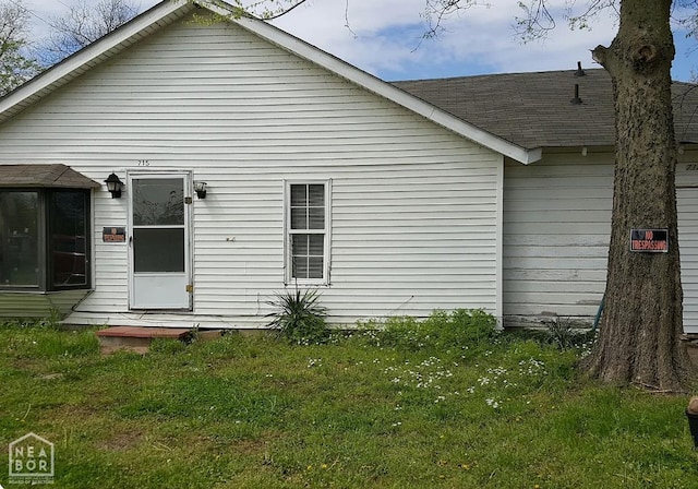 715 N Pine Ave, Trumann, AR 72472 - back of house featuring a lawn and roof with shingles