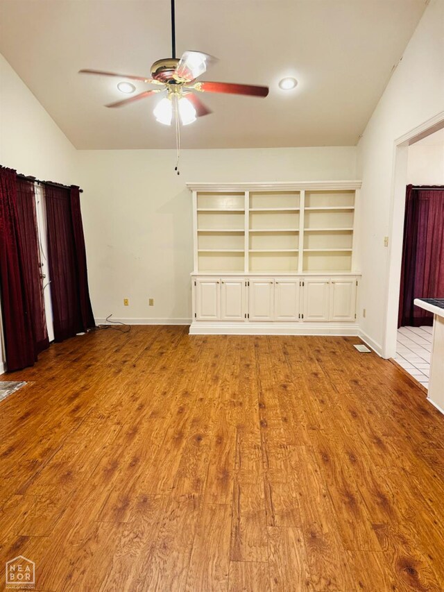 2208 John Cir, Newport, AR 72112 - unfurnished bedroom featuring baseboards, a ceiling fan, recessed lighting, wood finished floors, and vaulted ceiling