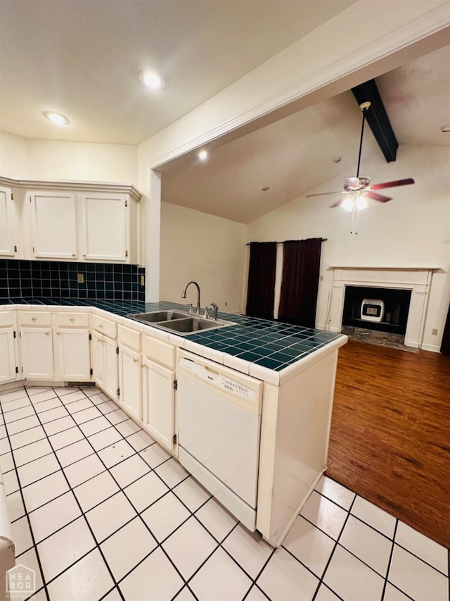 2208 John Cir, Newport, AR 72112 - kitchen featuring tile countertops, a peninsula, a ceiling fan, dishwasher, and a sink