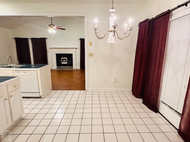 2208 John Cir, Newport, AR 72112 - kitchen with ceiling fan with notable chandelier, white cabinetry, dishwasher, a sink, and tile counters