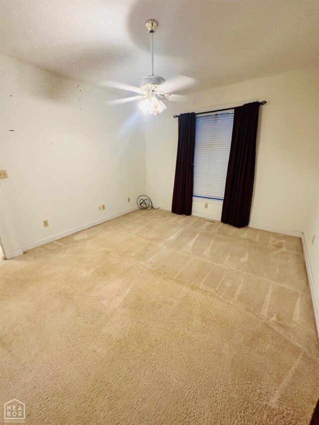 2208 John Cir, Newport, AR 72112 - unfurnished room with baseboards, a ceiling fan, and light colored carpet