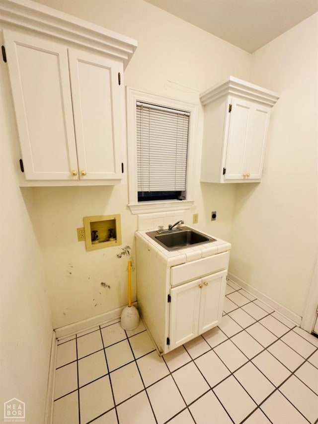 2208 John Cir, Newport, AR 72112 - washroom featuring hookup for an electric dryer, washer hookup, a sink, baseboards, and cabinet space