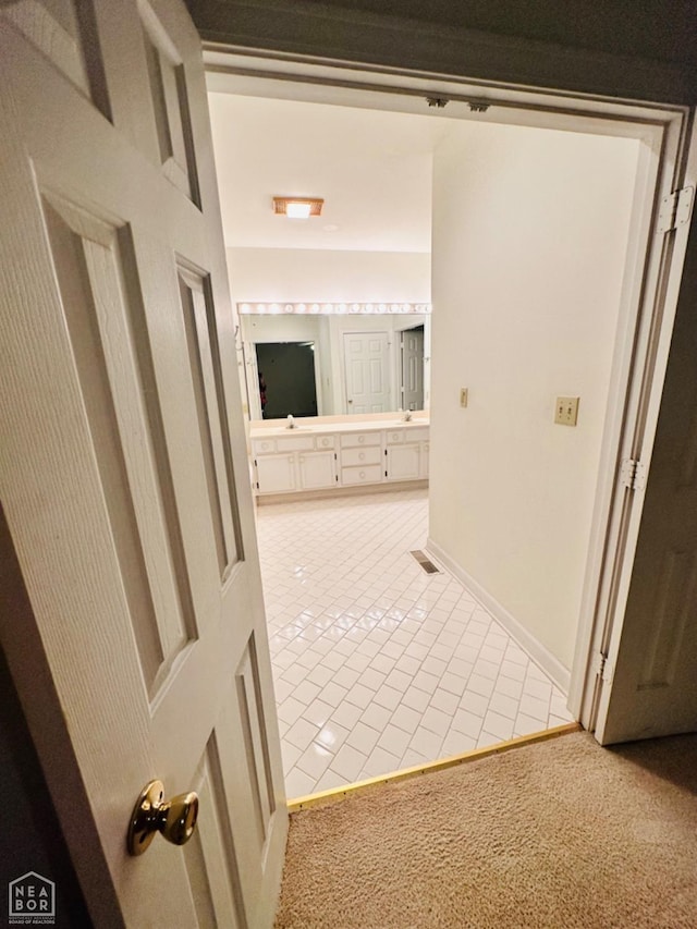 2208 John Cir, Newport, AR 72112 - hall featuring light carpet, light tile patterned floors, and baseboards