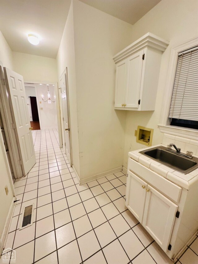 2208 John Cir, Newport, AR 72112 - clothes washing area with light tile patterned floors, hookup for a washing machine, visible vents, a sink, and cabinet space